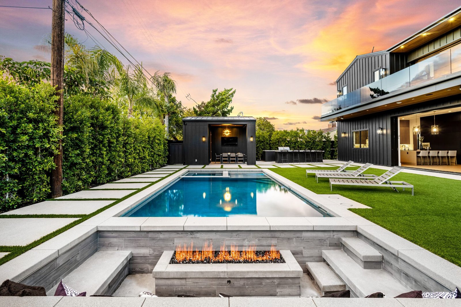 luxurious-backyard-with-pool-and-fire-pit-at-sunse